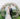 couple portrait in front of the lush circular wedding arch of pastel florals