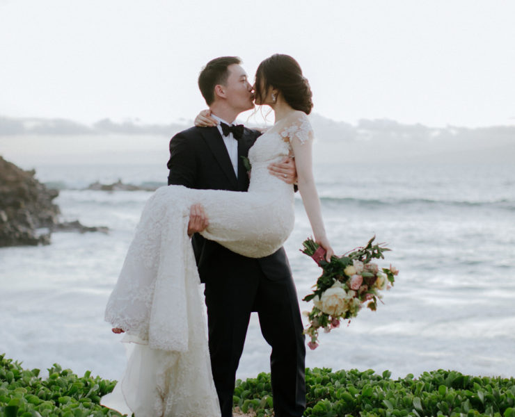 groom picks up his bride for a kiss