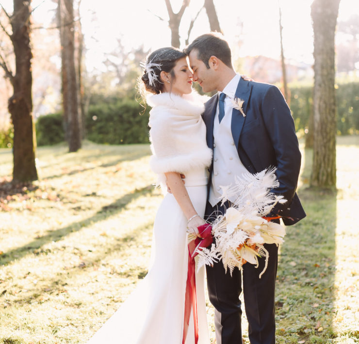 bride and groom lean in for a kiss during their winter wedding at an Italian castle