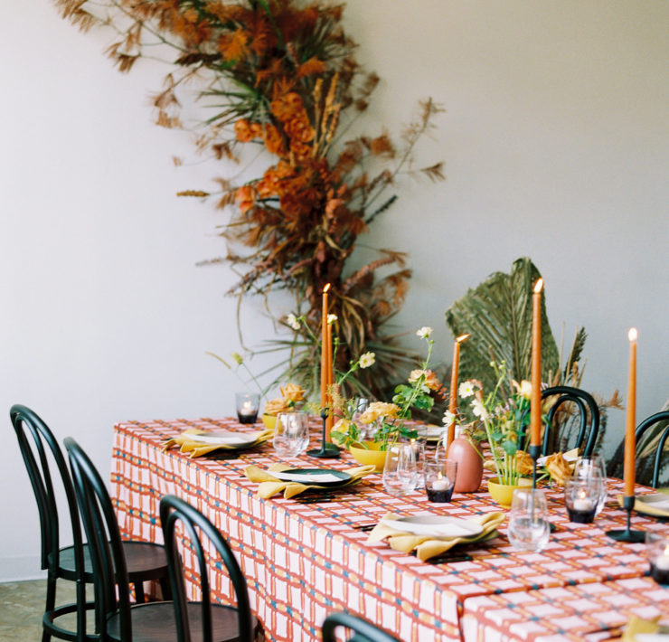 playful linens and tall burnt orange taper candles