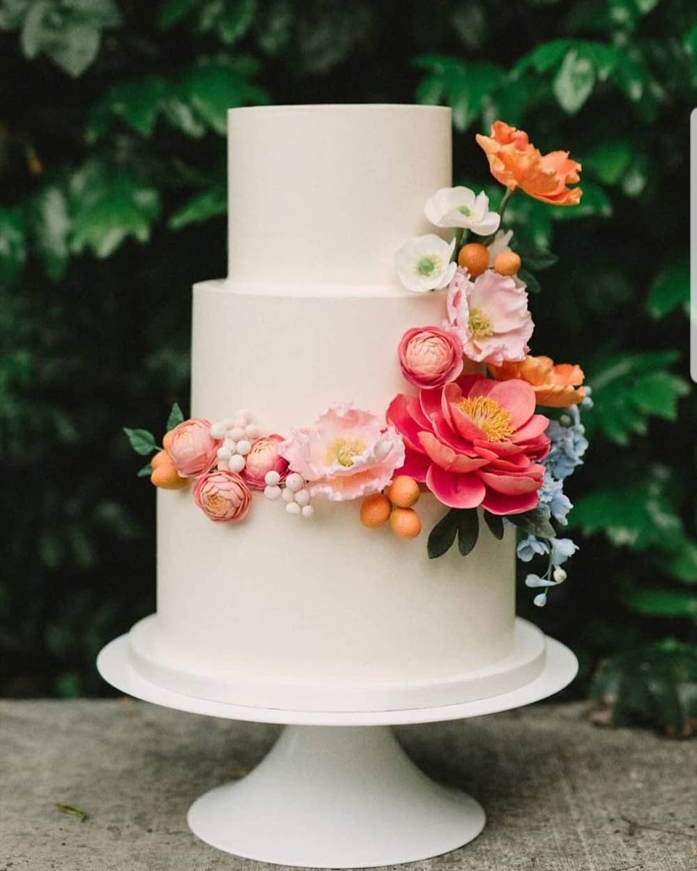 tiered spring wedding cake with fresh florals