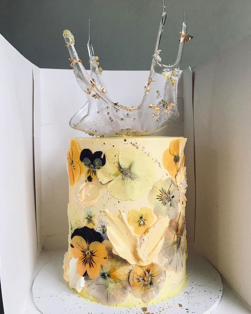 yellow spring cake with buttercream florals and glittery details