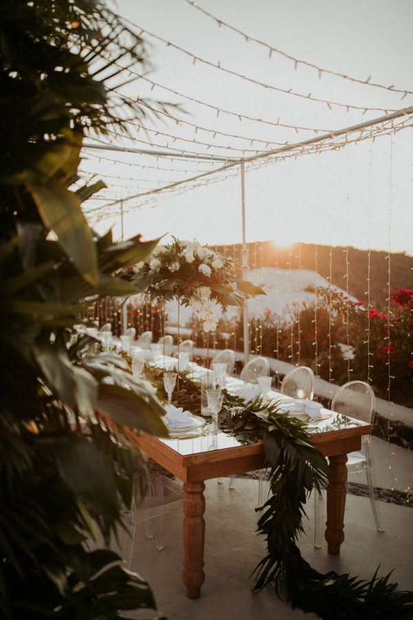 tropical white and green florals line the long reception table