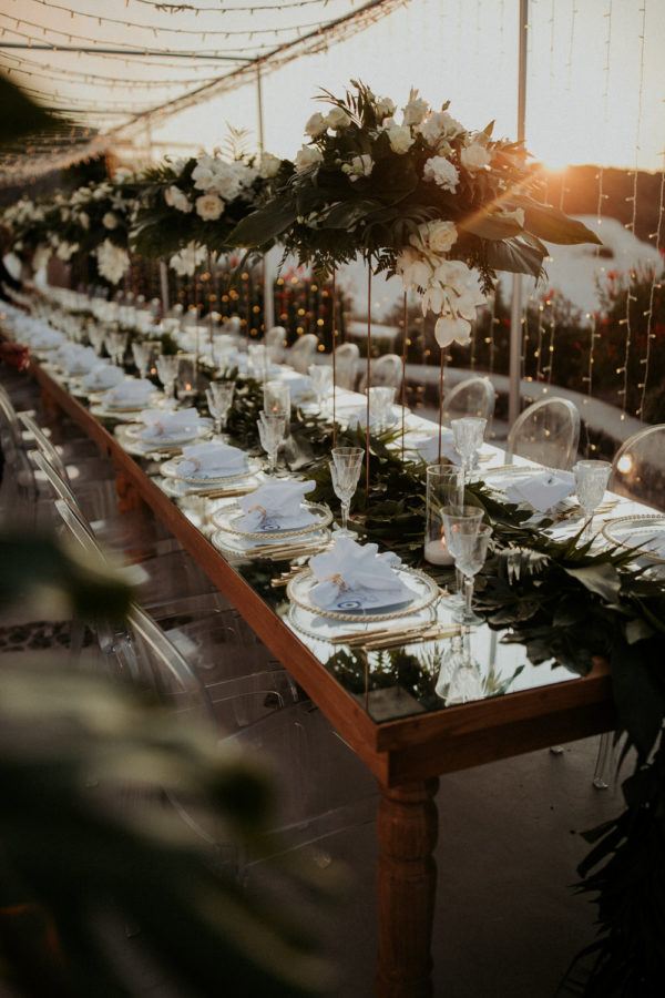 ghost chairs line the long reception table