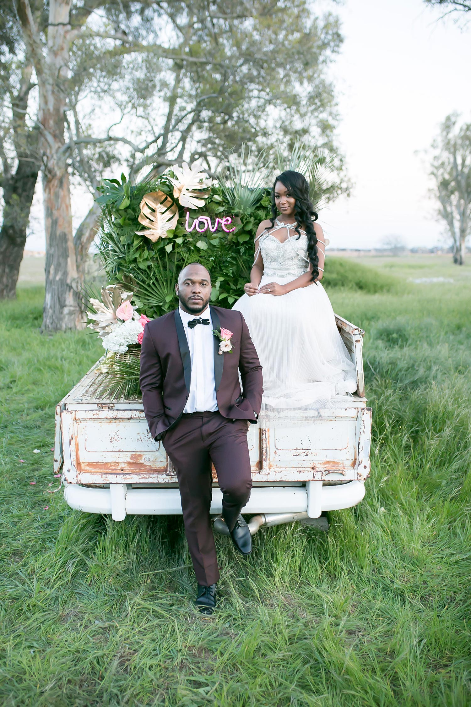 tropical wedding inspiration with an embellished wedding dress and burgundy groom suit