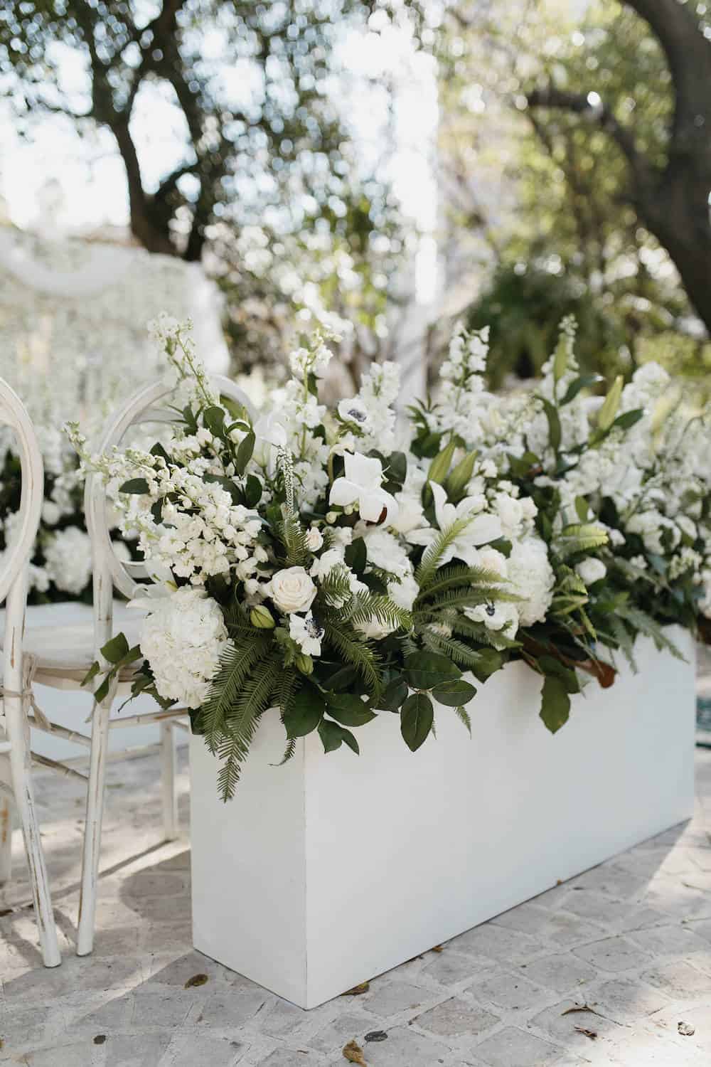 This White Carnation Flower Wall Was An Epic Surprise For The Groom Ruffled