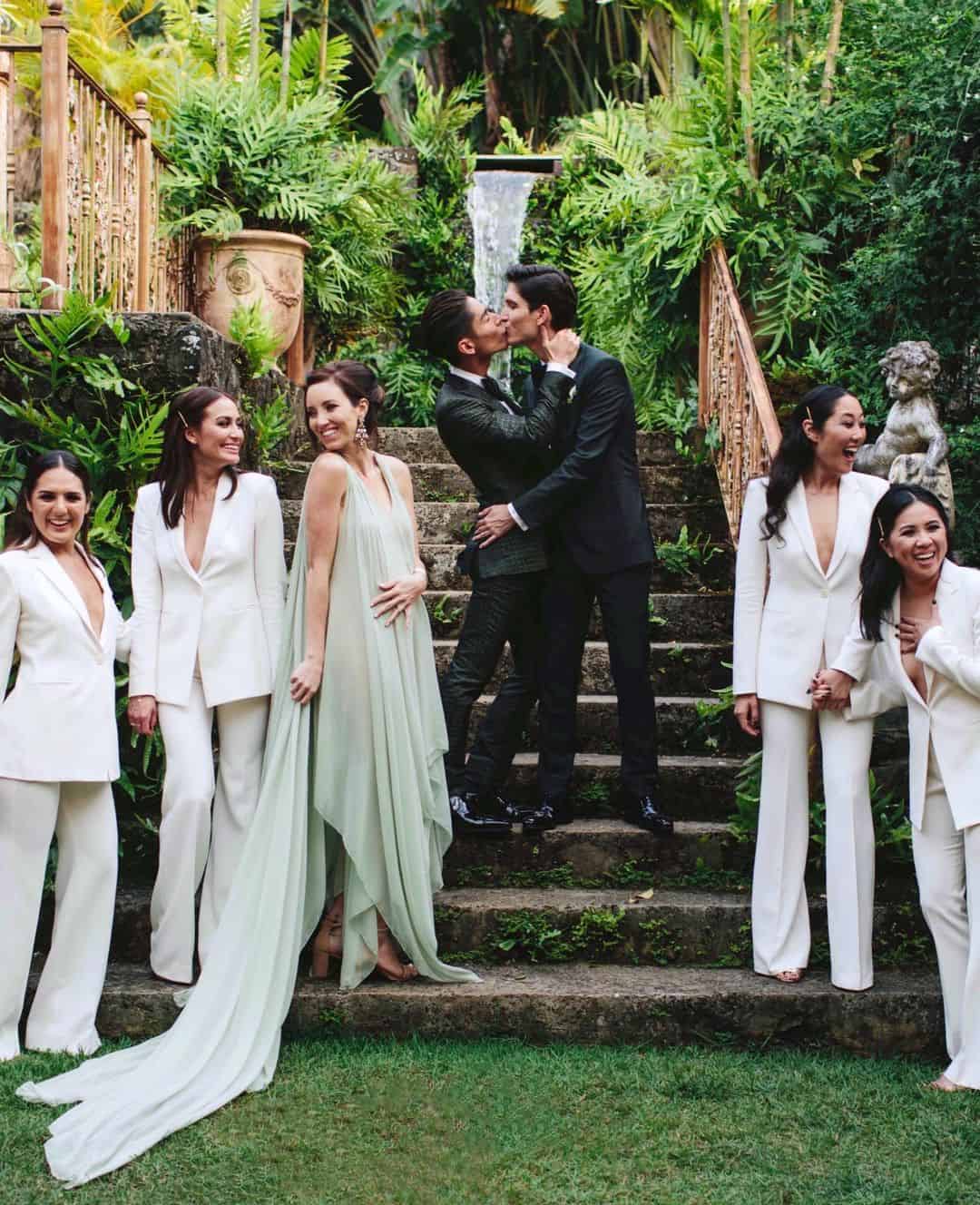 Haiku Mill staircase with two grooms and bridesmaids in chic white jumpsuits