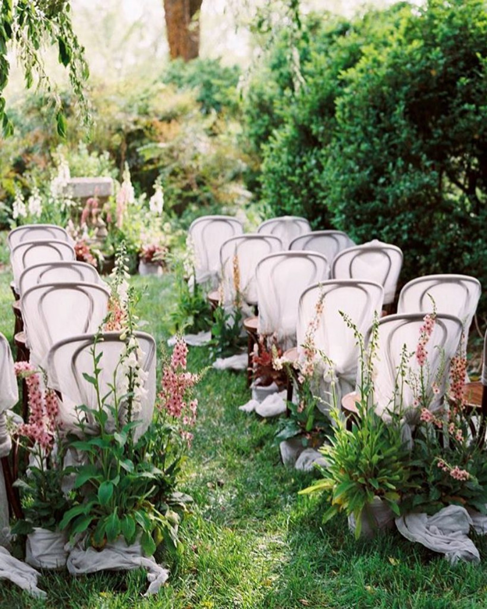 gauzy chair covers and oversized aisle flowers