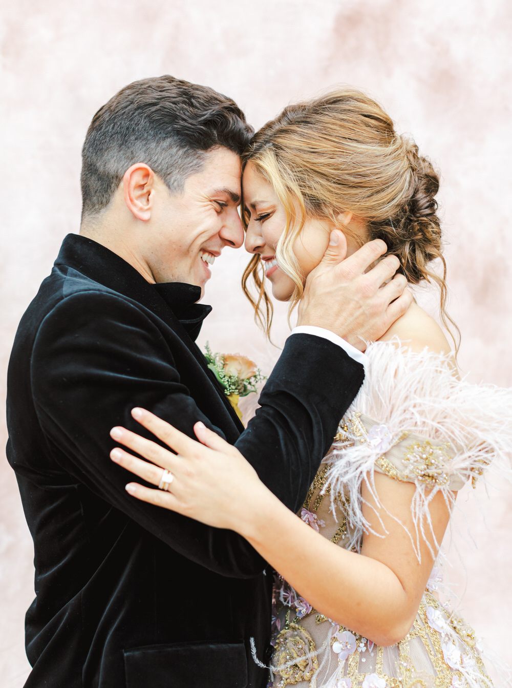 bride and groom laugh together during wedding portrait