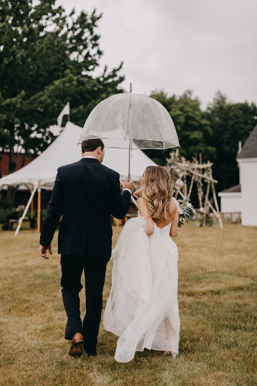 bride and groom rainy day wedding with umbrella