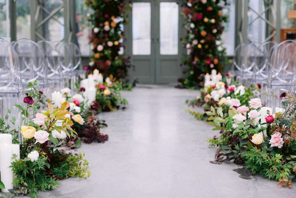 greenery and floral arch at greenhouse ceremony