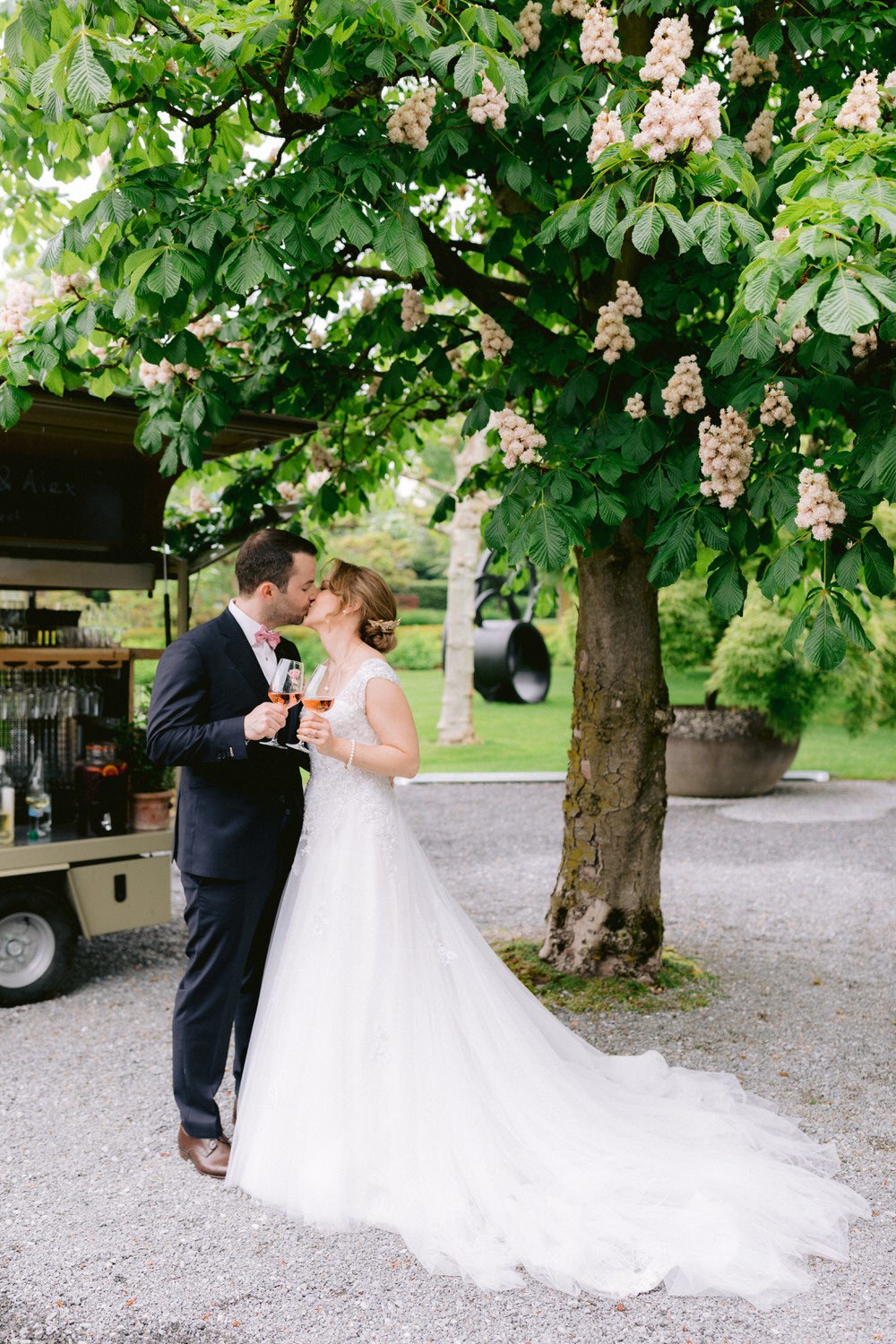 bride and groom kiss and cheers