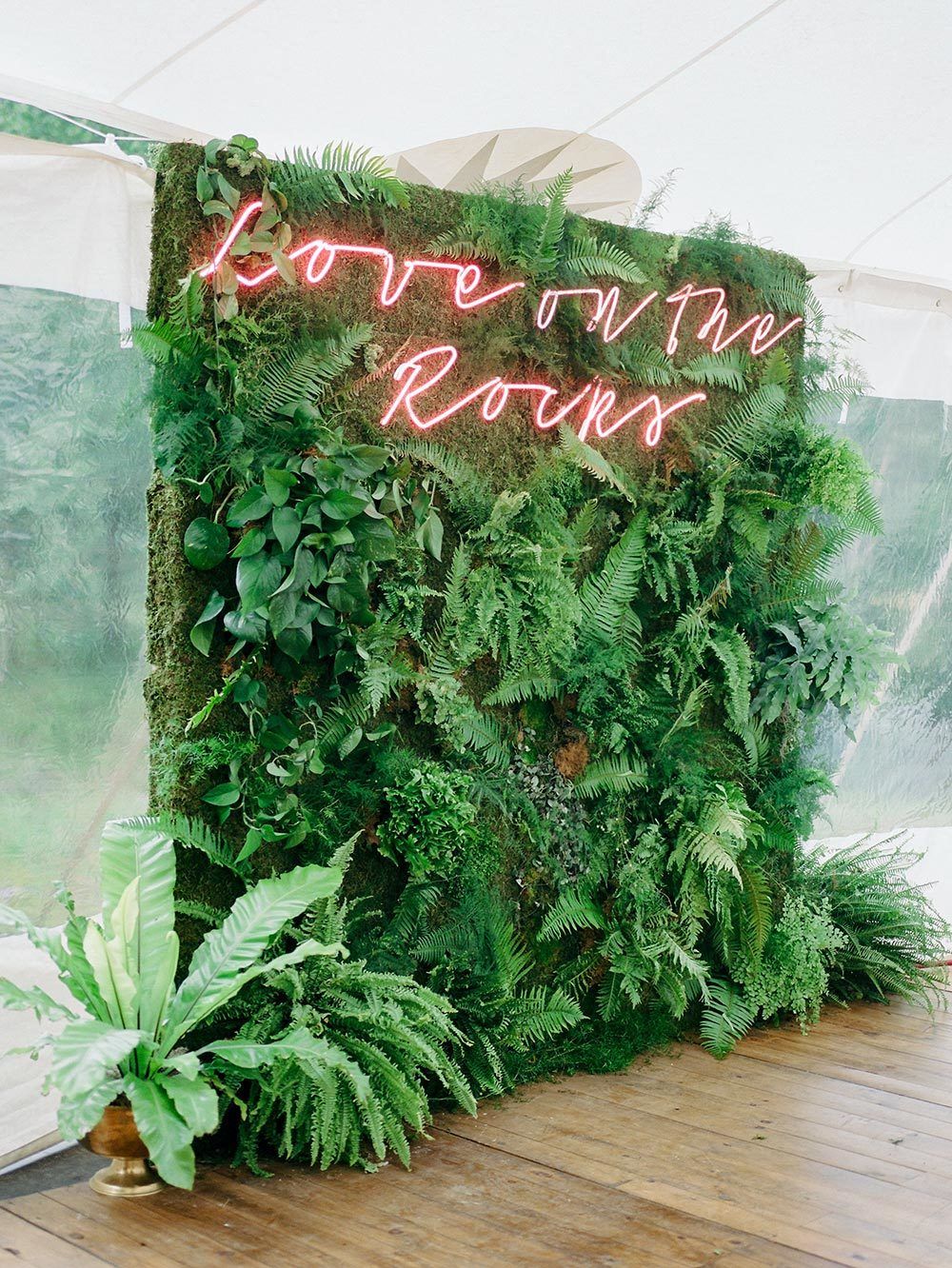 tropical photo booth backdrop with neon signage