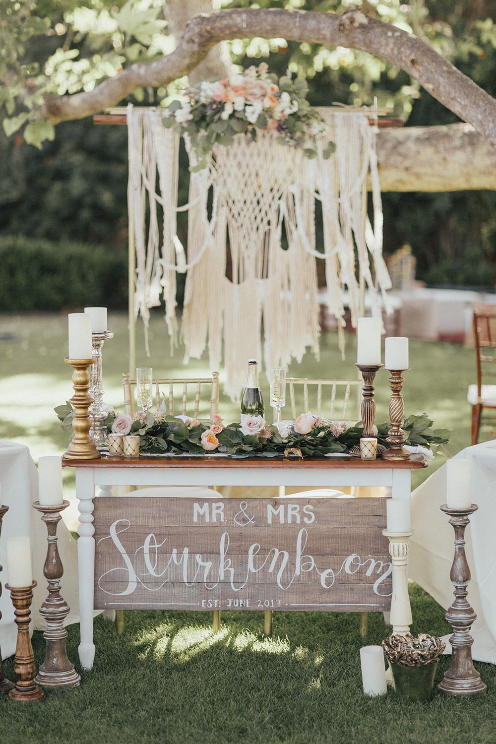 bohemian chic sweetheart table with macrame backdrop
