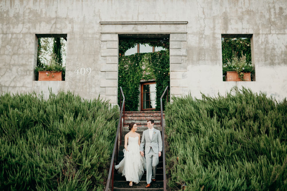 ruffled wedding dress and grey groom suit