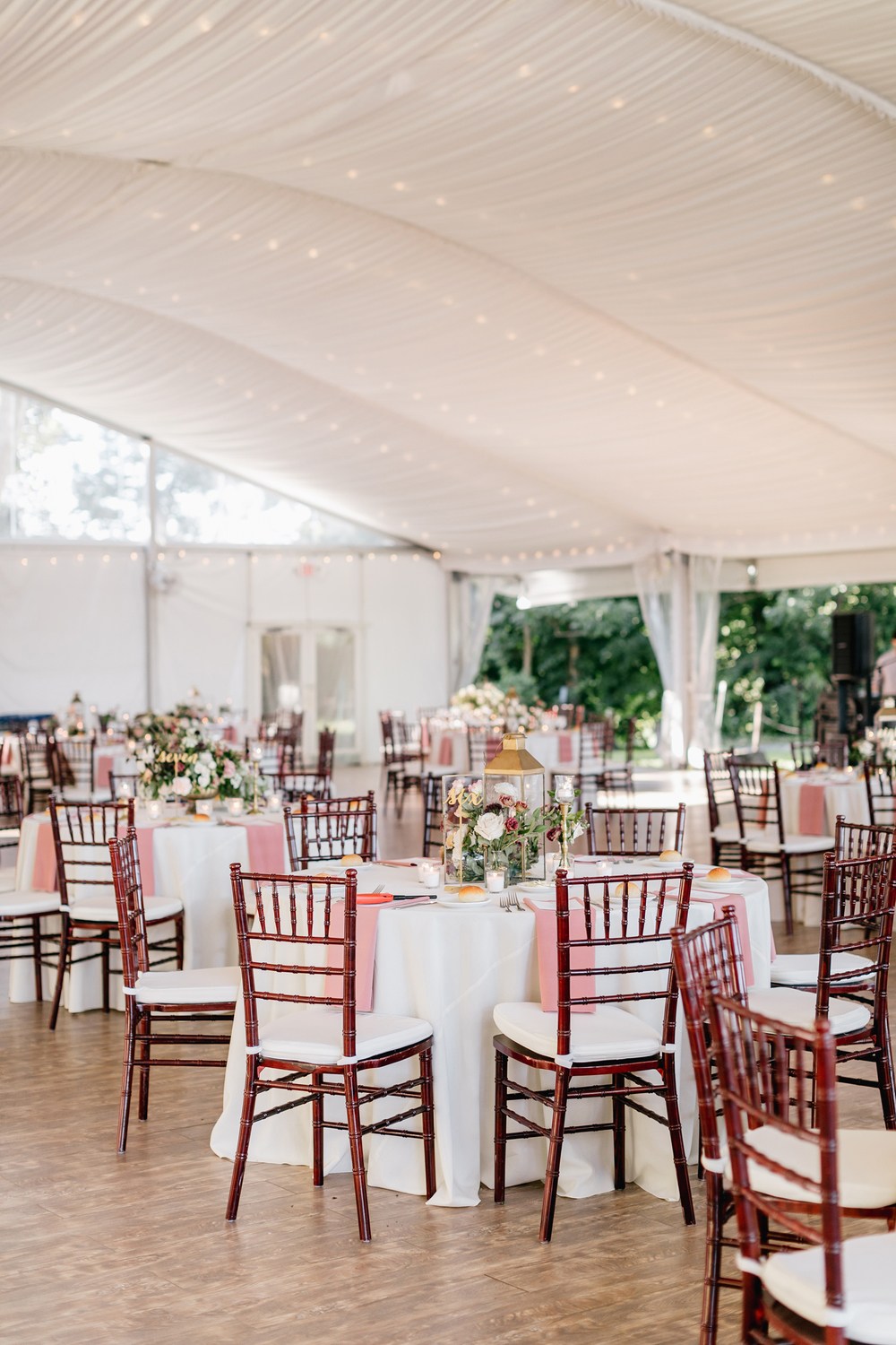 marquee wedding reception with chiavari chairs and peach colors