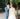 modern and classical longsleeve wedding dress and blue groom suit first look