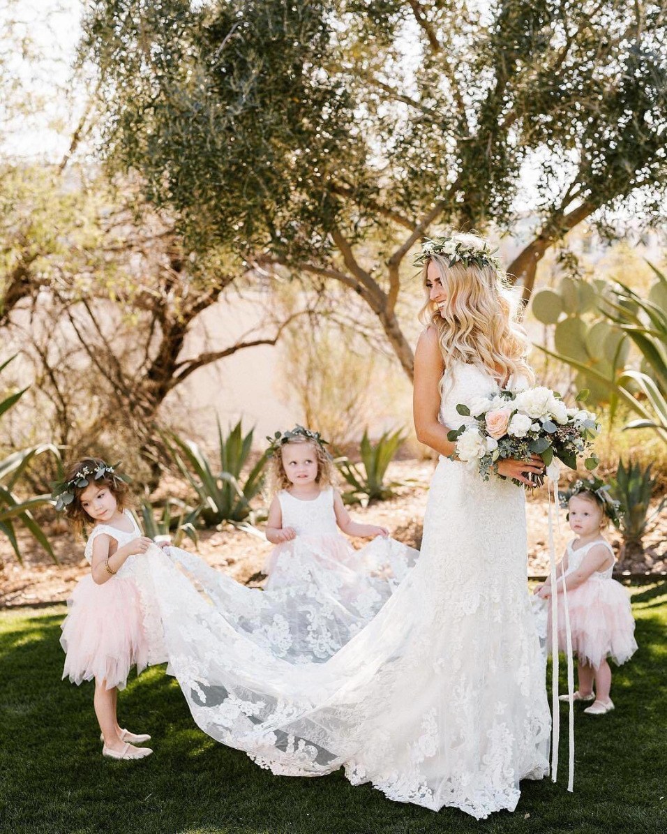 flower girls helping bride with her train