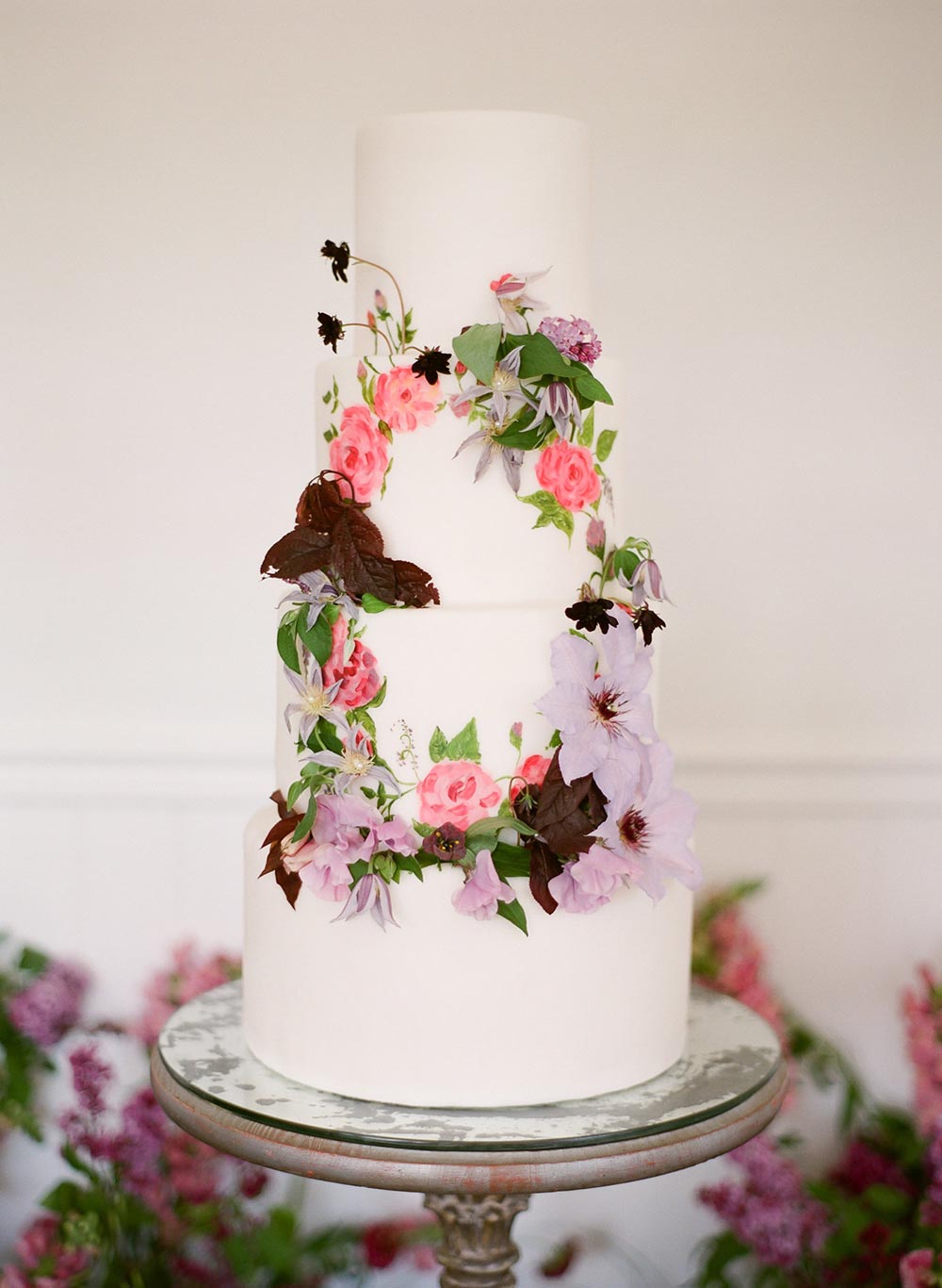 handpainted wedding cake with indoor garden of lupin flowers