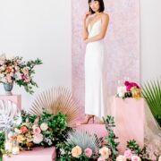 sleek spaghetti strap wedding dress and tropical floral display