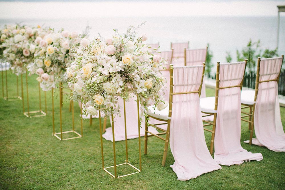 romantic modern wedding ceremony chairs with pink draping