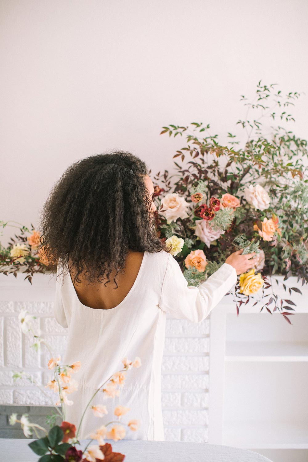 scoop back linen white dress and wild floral arrangement