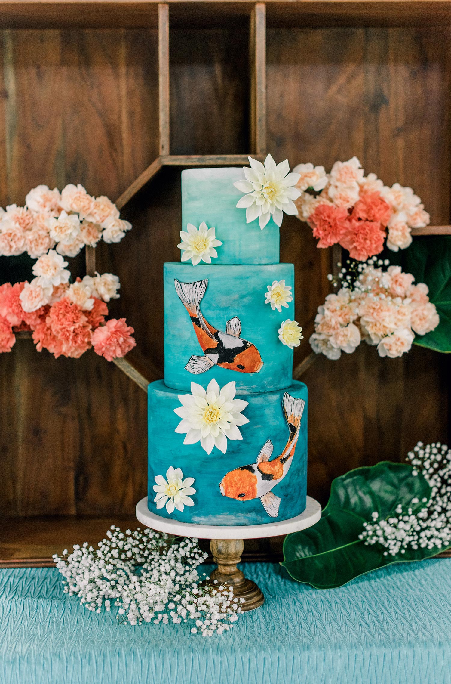 teal and orange koi fish wedding cake