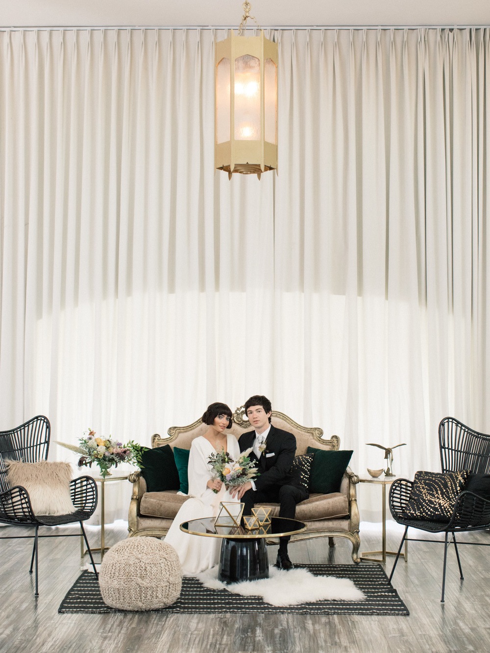 v-nceck wedding dress with flutter sleeves and black groom suit with bohemian lounge vignette