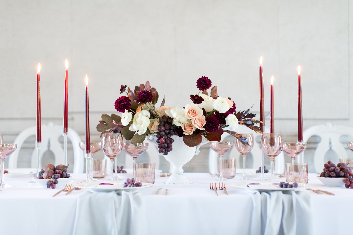manor wedding reception table with white dior chairs and marsala candles