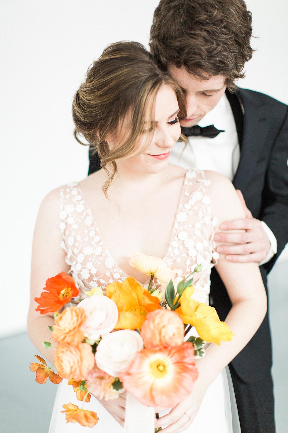 whimsical wedding dress with orange and yellow poppy bridal bouquet