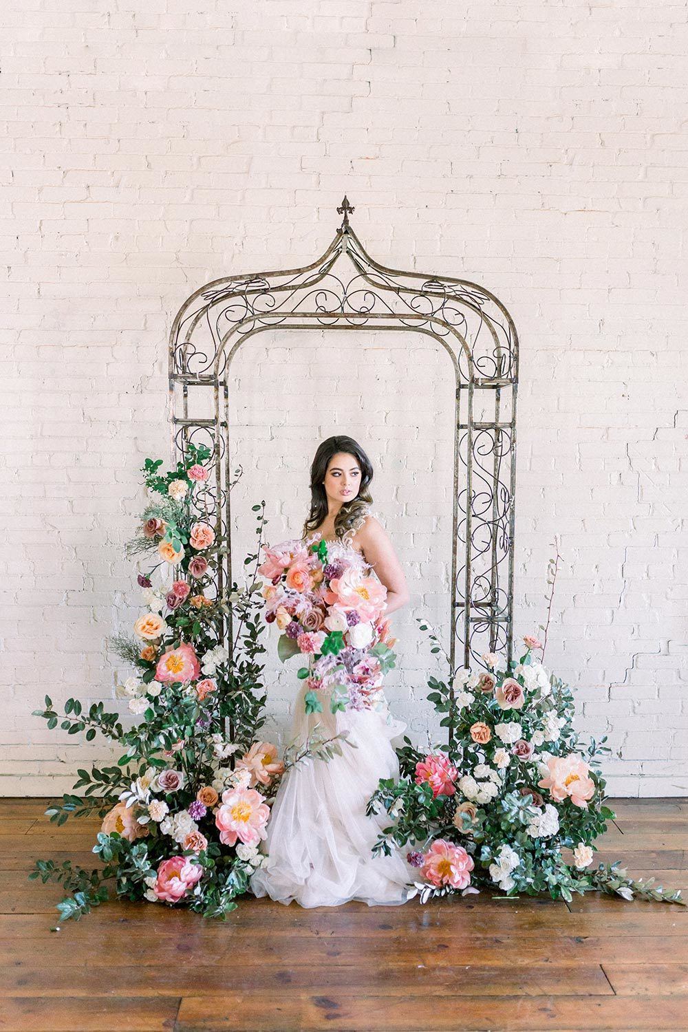lavender and pink floral arbor wedding ceremony backdrop