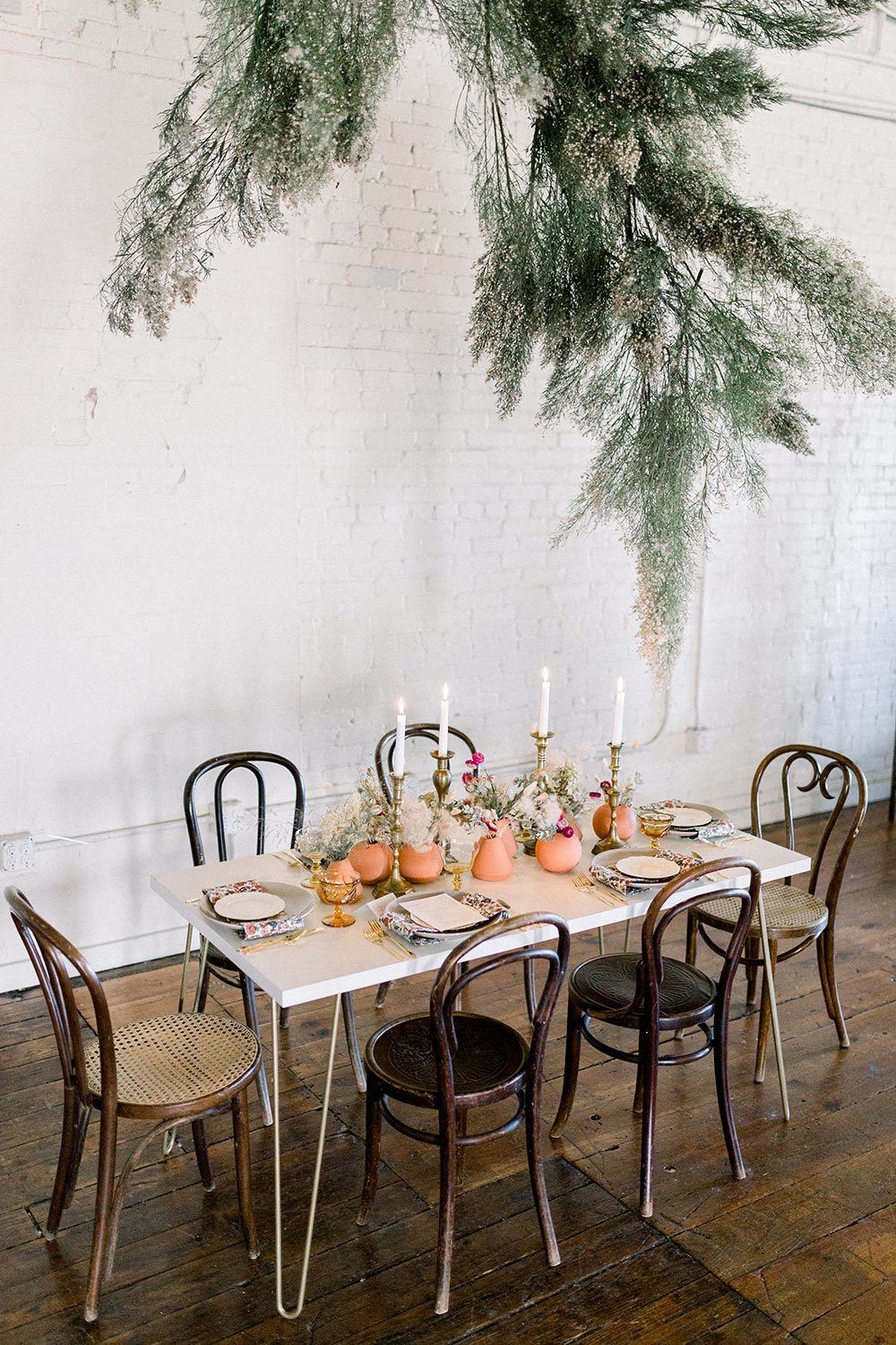 modern earth toned wedding inspiration with greenery floral installation