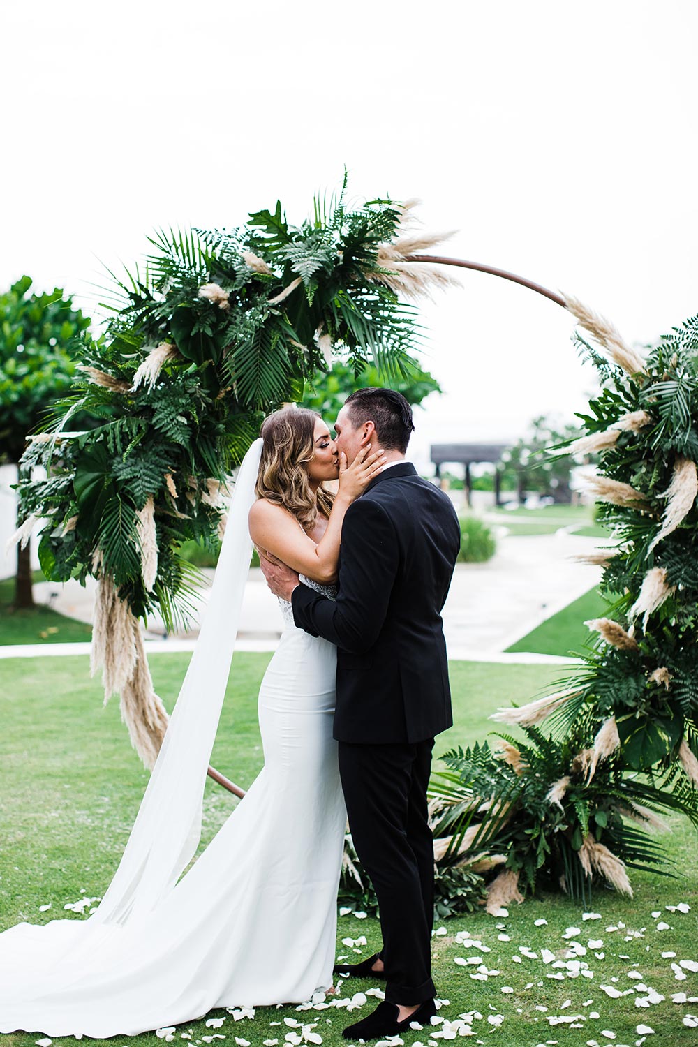 pampas grass and palm frond round wedding ceremony arbor