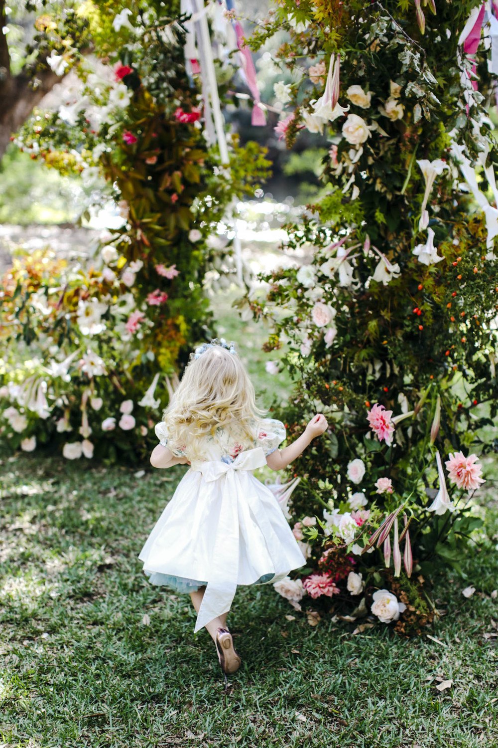 floral wedding chuppah with ribbons and french textiles with colorful flower girl dress