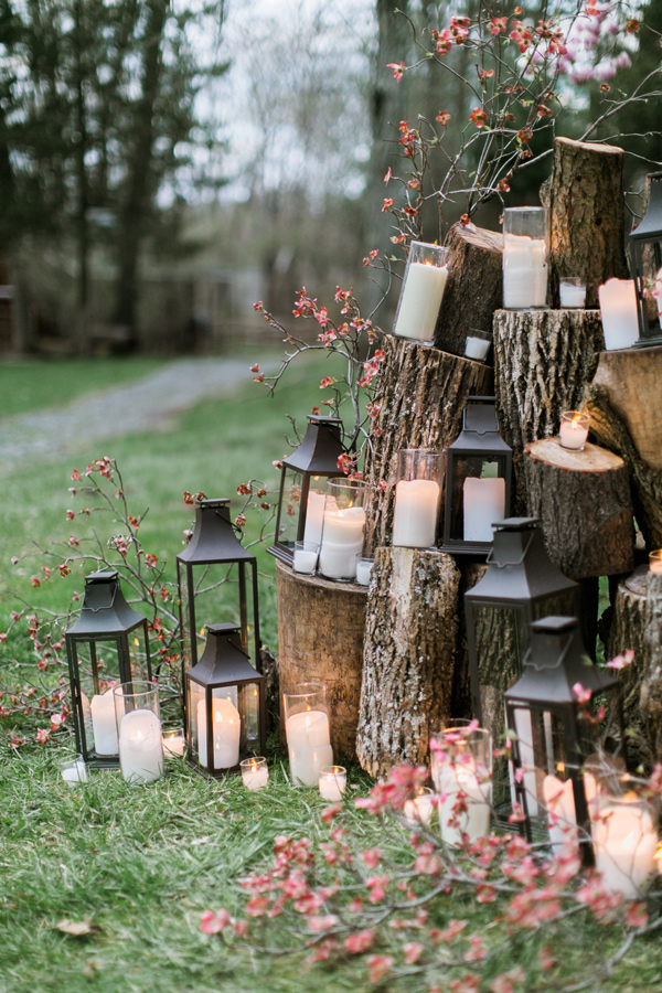 lantern and candle ceremony backdrop - photo by Emily Wren https://ruffledblog.com/woodland-romance-wedding-inspiration